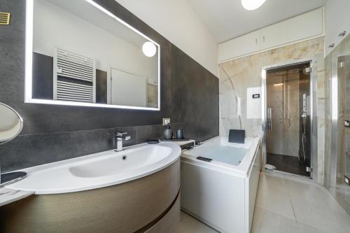 a bathroom with a sink and a washing machine at [Via Indipendenza] – Attico di lusso con Piscina in Bologna