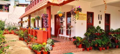 a flower shop with potted plants in front of it at Holidayincoorg - Brick lane in Madikeri