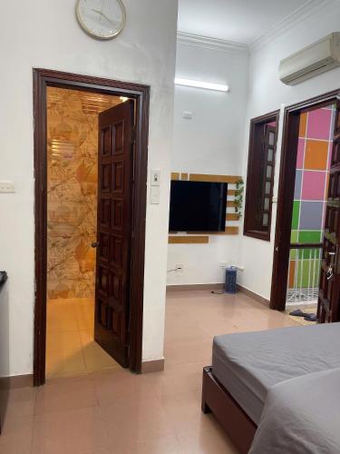 a room with a bed and a clock on the wall at Bamboo Homestay Old Quarter in Hanoi