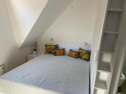 a room with a bed with pillows on it at Apartments Sia-M3 in Kopaonik