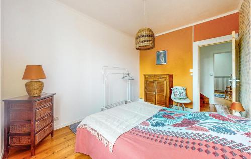 a bedroom with a bed and a dresser and a chair at 4 Bedroom Gorgeous Home In Jarnac in Jarnac