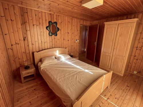 a bedroom with a bed in a wooden room at Pré Vert in Durbuy