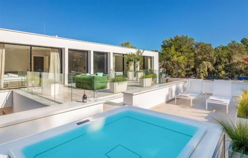 a swimming pool on the patio of a house at Villa Amber in Pakoštane
