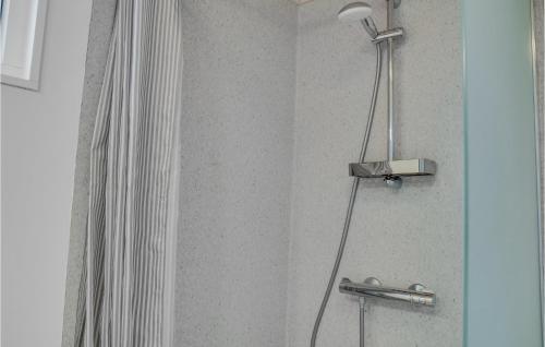 a shower with a shower head in a bathroom at Nice Apartment In Væggerløse With Wifi in Marielyst