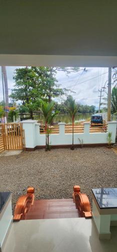 a view of a patio with chairs and a table at Punerjeni Homes in Alleppey
