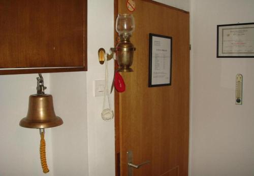 a door with a bell next to a wall at Rooms Branka in Križevci