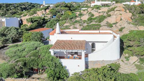a white house on the side of a hill at Villa Adea in Santa Teresa Gallura