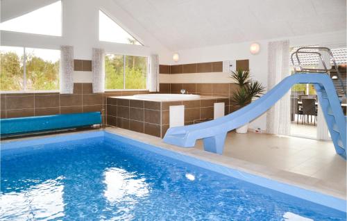 a swimming pool with a slide in a house at Amazing Home In Henne With Sauna in Henne Strand