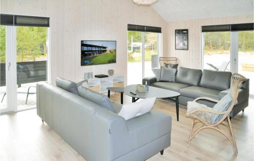 a living room with a couch and a table at Amazing Home In Henne With Sauna in Henne Strand