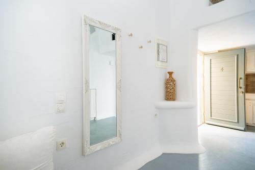 a mirror on a white wall in a hallway at 5 Traditional Suites in Livadi Astypalaias