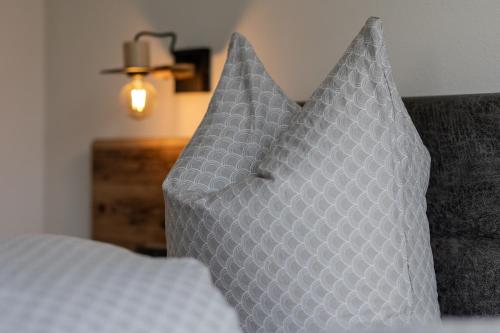 a pair of pillows sitting on a bed at Appart Zellblick in Zellberg
