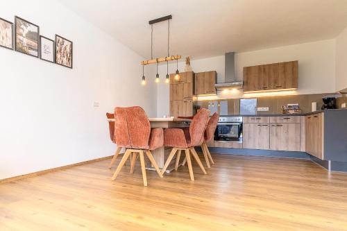 a kitchen and dining room with a table and chairs at Appart Zellblick in Zellberg