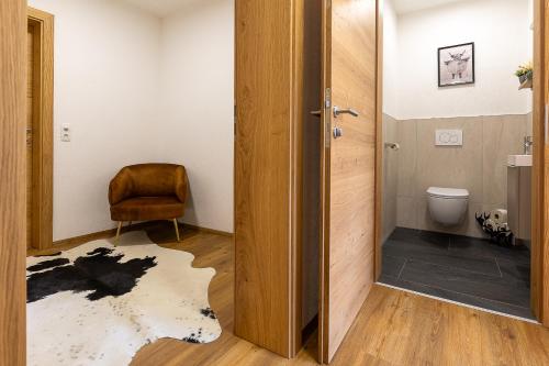a bathroom with a door open to a toilet at Appart Zellblick in Zellberg