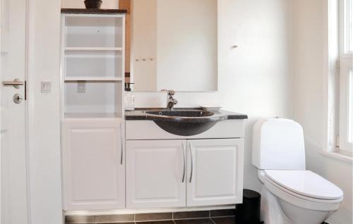 a bathroom with a sink and a toilet at Holiday Home Gøgevej Henne I in Henne Strand