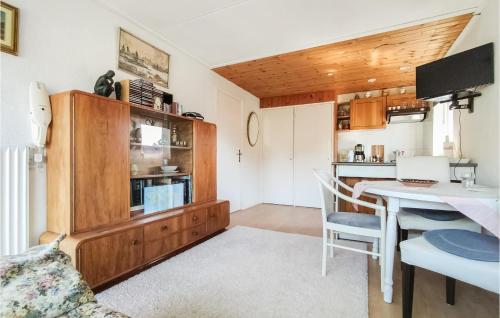 a kitchen and dining room with a table and a dining room at Stunning Apartment In Vlissingen in Vlissingen