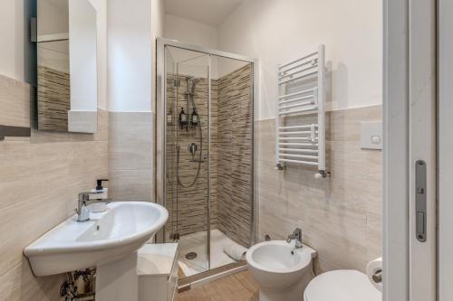 a bathroom with a sink and a toilet and a shower at V E N E R E Apartments in Rome
