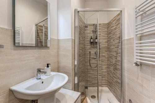 a bathroom with a sink and a shower at V E N E R E Apartments in Rome