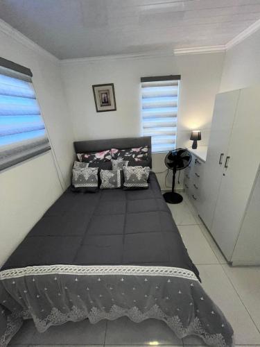 a bedroom with a large black bed in a room at The MK House in Cape Town