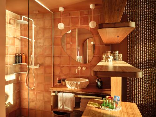 a bathroom with a sink and a mirror at Bikini Island & Mountain Hotel Es Trenc -Adults only- in Colonia Sant Jordi