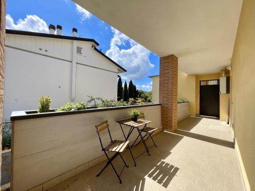 a balcony with two chairs and a table on a building at Marty's House in Arezzo