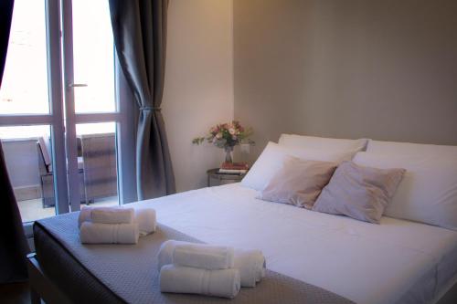 a bedroom with a large white bed with two pillows at Il Piccolo Attico comfort house in Viterbo
