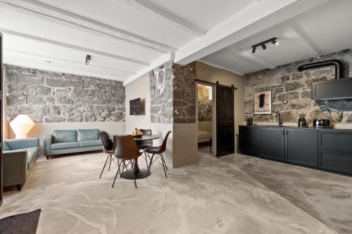 a living room with a stone wall at Amazing Design Apartment in Downtown Reykjavik in Reykjavík