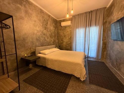 a small bedroom with a bed and a window at Central luxury apartment in Patra