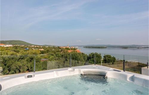 a hot tub with a view of the water at Amazing Home In Pasman in Živica