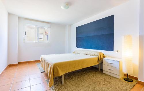 a bedroom with a bed and a blue painting on the wall at Beautiful Home In Oropesa Del Mar in Oropesa del Mar
