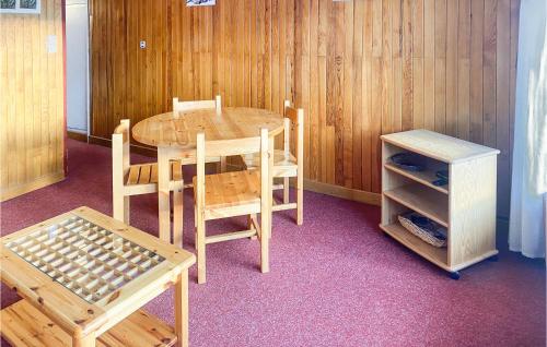 une table et des chaises en bois, une table et une armoire dans l'établissement Cozy Apartment In Orcières With Wifi, à Orcières