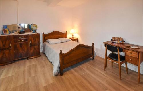 a bedroom with a bed and a dresser and a desk at Nice Home In Marsanne in Marsanne