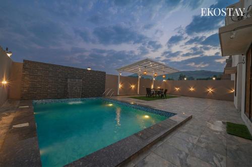 a swimming pool in the backyard of a house at EKOSTAY - Ivana Villa in Lonavala