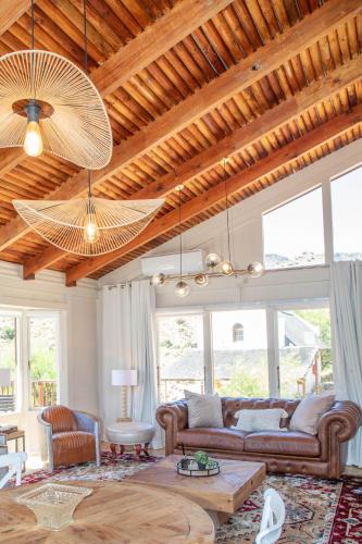 a living room with a couch and a wooden ceiling at Bushman Valley in Prince Albert