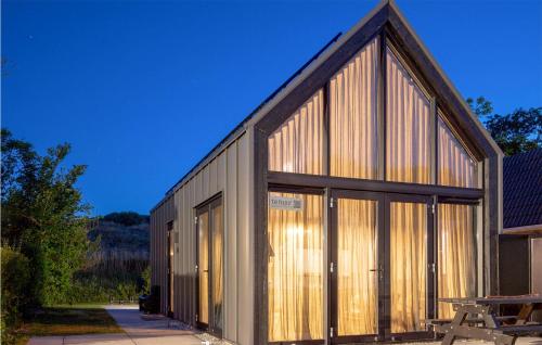a building with large glass doors and a roof at Pet Friendly Home In Vlissingen in Vlissingen