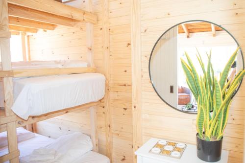 a bedroom with two bunk beds and a mirror at Bushman Valley in Prince Albert