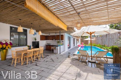 a patio with a table and chairs and a swimming pool at 3B - Trệt Không Lầu - Phong Cách Đà Lạt in Vung Tau
