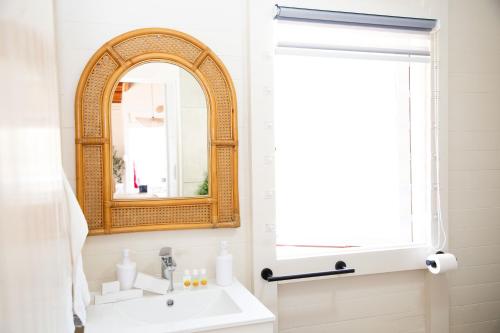 a bathroom with a sink and a mirror at Bushman Valley in Prince Albert