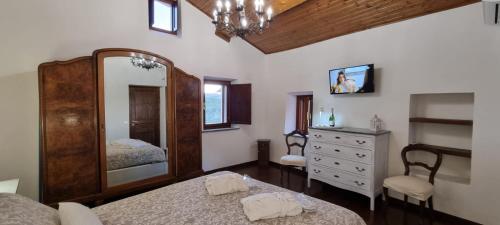 a bedroom with a large mirror and a dresser at La casa di Agnese in Fiuggi