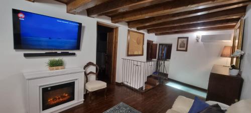 a living room with a television and a fireplace at La casa di Agnese in Fiuggi