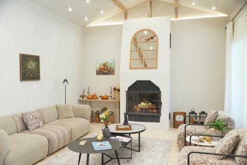 a living room with a couch and a fireplace at Villa Alma 1910 Starosel in Starosel