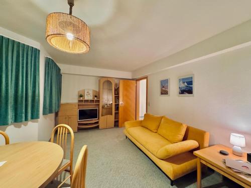 a living room with a couch and a table at Appartement Davis-Birkl in Sankt Anton am Arlberg