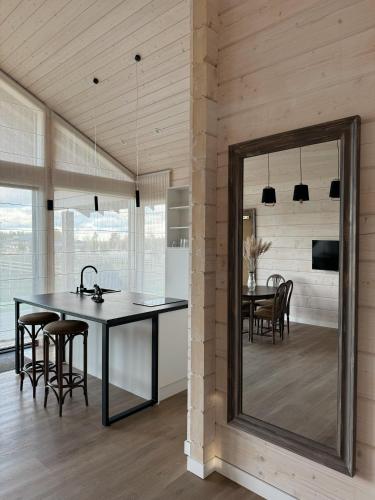 a dining room with a table and a mirror at Royal Horse Resort in Balkasodis