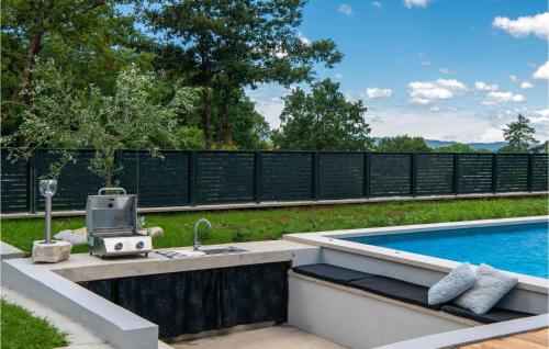 a backyard with a swimming pool and a sink next to a swimming pool at Amazing Home In Krsan With Sauna in Kršan