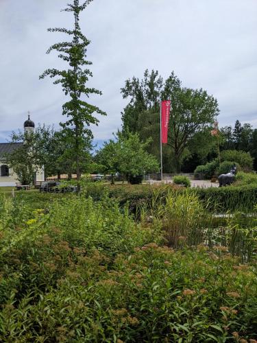 a red flag on a pole in a garden at Hofgut Algertshausen in Eresing