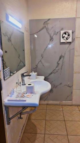 a bathroom with a sink and a mirror at Al Orouba Hotel in Riyadh