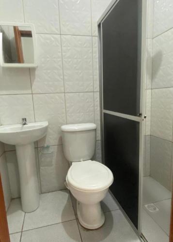 a bathroom with a toilet and a sink at Hotel PALLACE in Belém