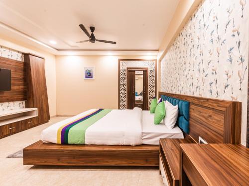 a bedroom with a king sized bed in a room at Lemon wood suites in Pune