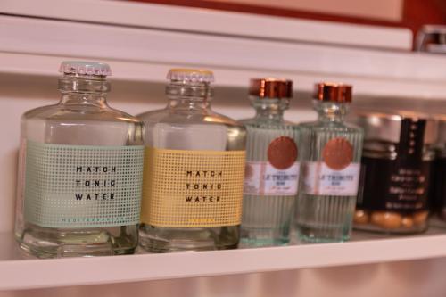 a shelf with several bottles of water on it at Mirador de Dalt Vila-Relais & Chateaux in Ibiza Town