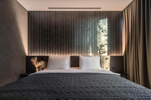 a bedroom with a large bed with two pillows at Verholy Relax Park in Sosnovka