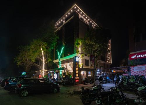 a building with lights on the side of it at night at Lemon wood suites in Pune
